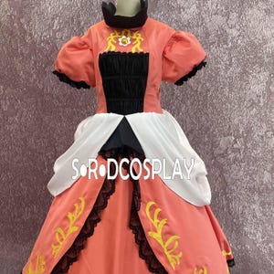 May include: A coral-colored cosplay dress with a black bodice and white skirt panels. The dress features gold embroidered accents, black lace trim, and short, puffed sleeves. The text "SORODCOSPLAY" is visible on the skirt.