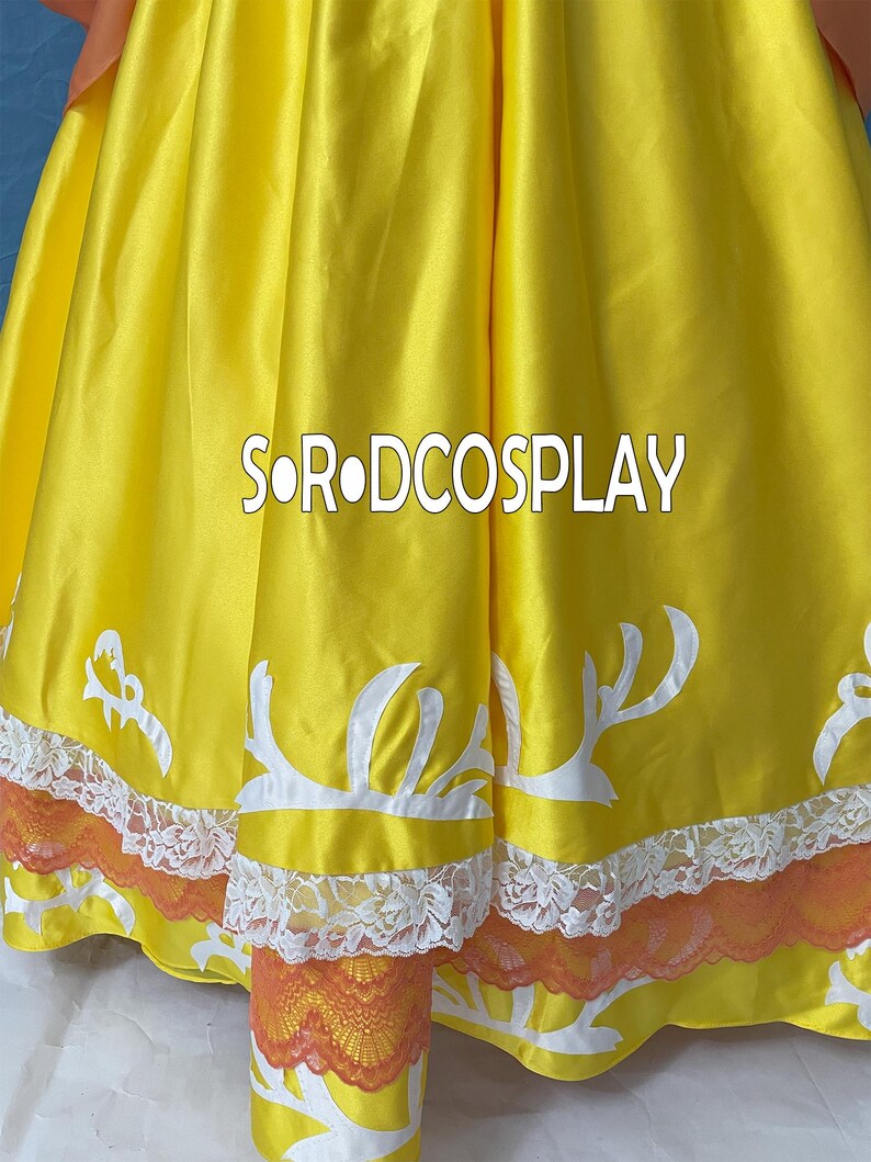 May include: A close-up of a yellow dress with white decorative accents and orange lace trim. The text "SORODCOSPLAY" is printed in white across the dress. The dress has a satin-like sheen.