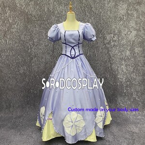 May include: A light purple ball gown with short puff sleeves and a square neckline. The bodice features dark purple accents and a pearl trim. The skirt has large white flower appliqués and a yellow underskirt. The text "SORODCOSPLAY" and "Custom made on your body sizes" are visible.