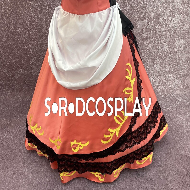 May include: A coral-colored costume skirt with black lace trim and yellow floral accents. The skirt features the text "S O R DCOSPLAY" in white. A white draped fabric is visible at the top of the skirt.