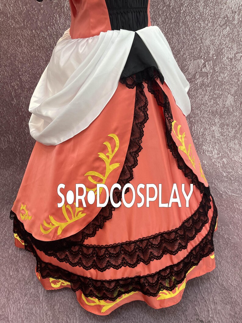 May include: A coral-colored dress with black lace trim and yellow accents. The dress features a white draped fabric over the shoulders and the text "S.R.ODCOSPLAY" in white. The dress appears to be a costume.