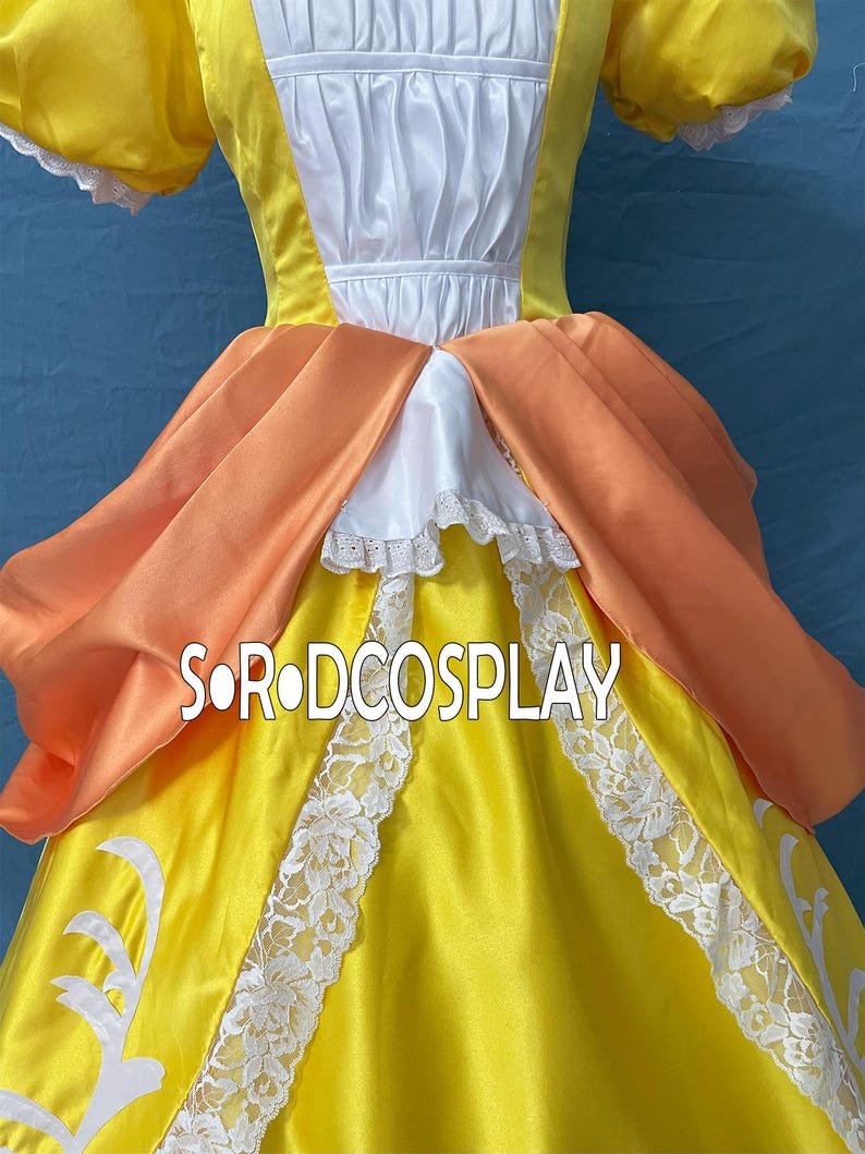May include: A yellow cosplay dress with white lace trim and orange accents. The dress features a white bodice and a layered skirt. The text "SORODCOSPLAY" is visible on the front of the dress.