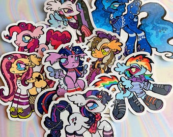 May include: A collection of colorful, stylized pony stickers. Each sticker features a unique design with vibrant colors, including pink, blue, purple, and rainbow hues. The stickers showcase various pony characters with detailed artwork and expressive features.