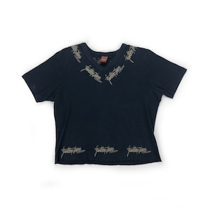 May include: A black short-sleeved t-shirt with a v-neck and gold embroidery around the neckline and hem.
