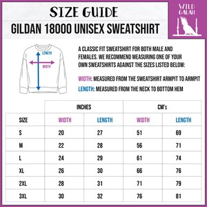 May include: Size guide for a Gildan 18000 unisex sweatshirt. The chart shows measurements in inches and centimeters for sizes S through 3XL. The measurements include width, measured from armpit to armpit, and length, measured from the neck to the bottom hem.