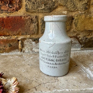May include: White ceramic jar with black lettering that reads "Deux Médailles d'Or Expon Univ.le Paris 1878.  MOUTARDE-BORDIN Le prix de la Bretonnnerie PARIS."
