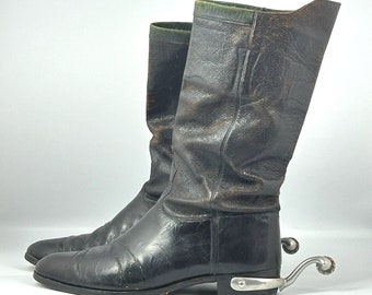 May include: A pair of black leather riding boots with a green top and silver spurs.