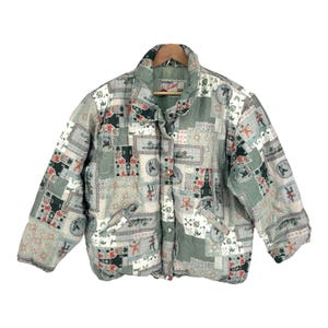 May include: A green, white, and red patterned puffer jacket with a button closure. The jacket has a quilted design and features a variety of small, colorful images.
