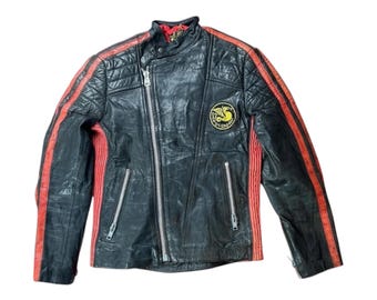 May include: Black leather motorcycle jacket with red and black stripes down the sleeves. The jacket has a zipper closure and a patch on the left side that says "Goldy Sport".