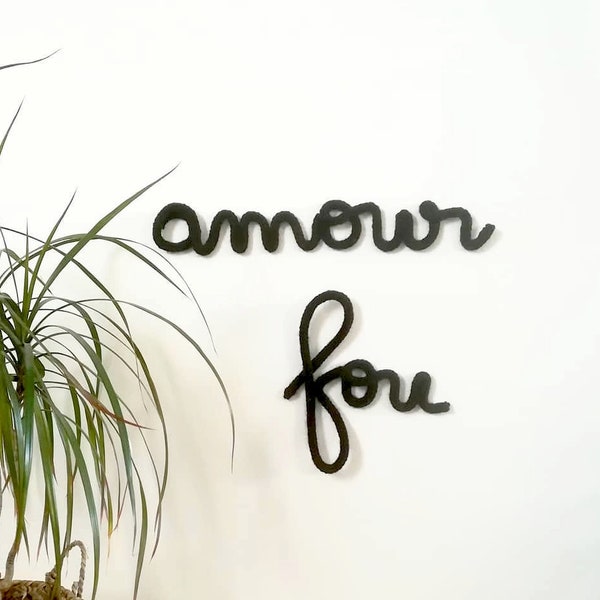 Knitting "amour fou", knitting love, black woolen knitting, decorative knitting, knitted word "amour" (means "love" in French)