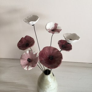 7 small marbled plum-white, plum and white ceramic flowers on wire