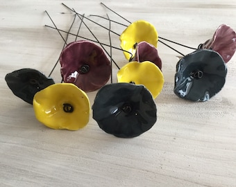 9 small plum, blue-grey and yellow ceramic flowers on wire