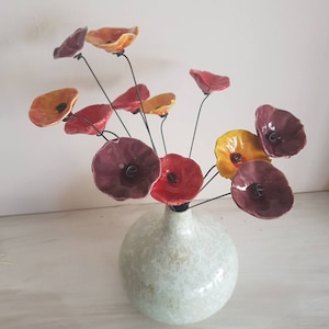 12 small plum, red and orange-yellow ceramic flowers on wire