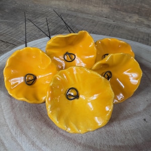 5 small yellow-orange ceramic flowers on wire