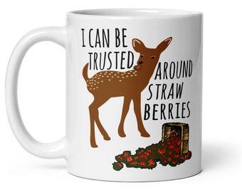May include: White ceramic coffee mug with a brown deer illustration and the text "I can be trusted around strawberries".