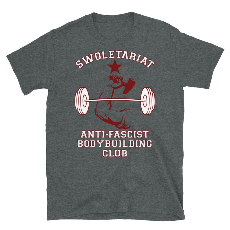 May include: A dark grey t-shirt with a red graphic of a bicep lifting a barbell with a red star and the text "SWOLETERIAT ANTI-FASCIST BODYBUILDING CLUB".
