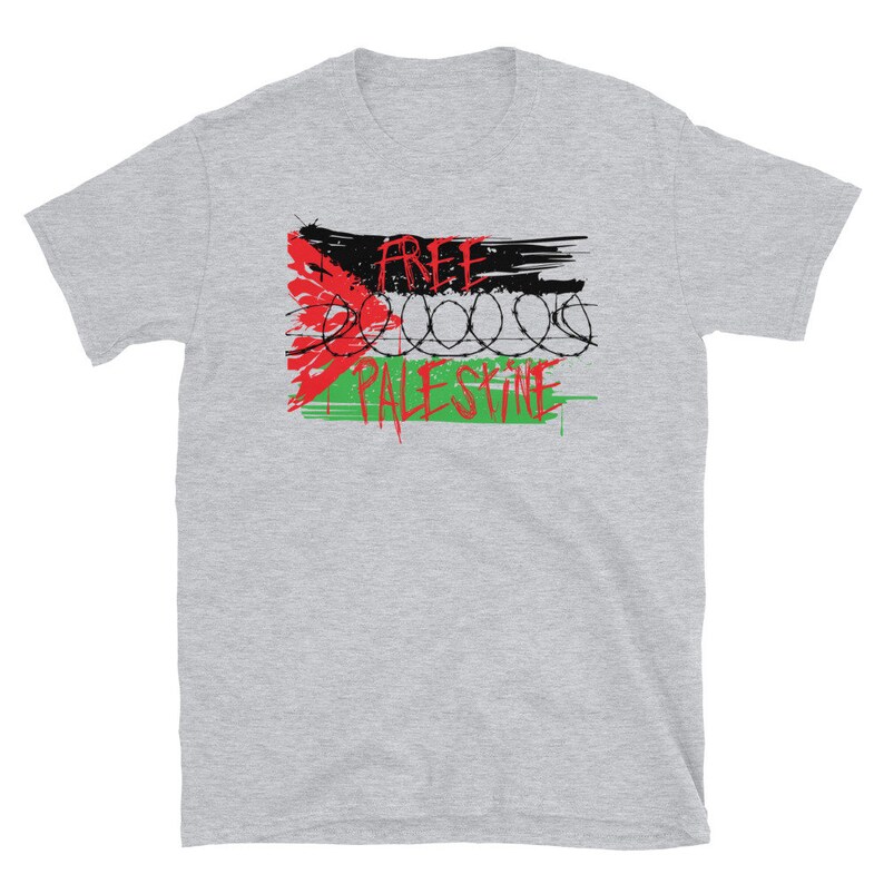 May include: A gray t-shirt with a red, black, and green graphic design. The graphic features a stylized Palestinian flag with barbed wire and the words "Free Palestine".