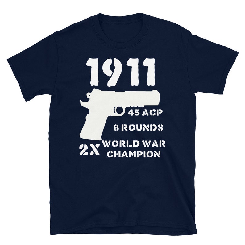 May include: Navy blue t-shirt with a white silhouette of a 1911 pistol, the text "1911", "45 ACP", "8 Rounds", "2X World War Champion" printed on the front.