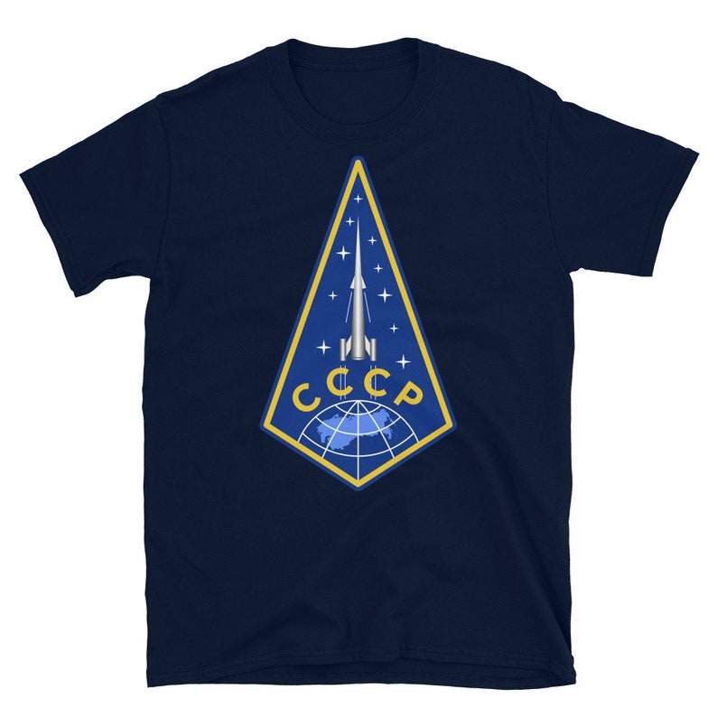 May include: A navy blue t-shirt with a yellow and blue emblem featuring a rocket and the text "CCCP".