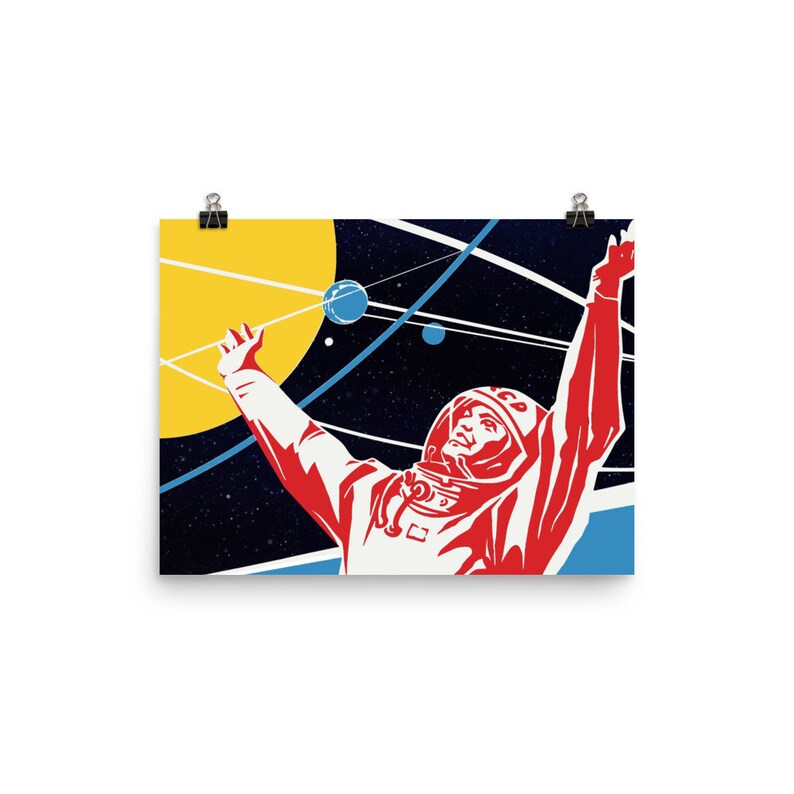 May include: A retro-style poster featuring a red and white astronaut in a space suit with his arm raised, against a dark blue background with yellow and blue planets and stars. The astronaut is wearing a helmet with the letters "CCCP" on it.