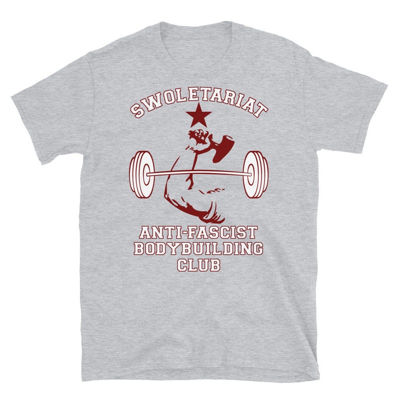 May include: Grey t-shirt with a red graphic of a bicep lifting a barbell. The graphic includes a red star and the text "SWOLETERIAT ANTI-FASCIST BODYBUILDING CLUB".