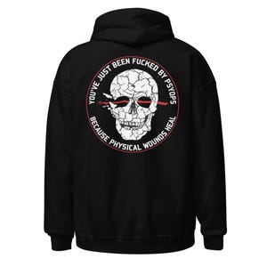 May include: Black hooded sweatshirt with a graphic on the back. The graphic is a white skull with red accents and text that reads "YOU'VE JUST BEEN FUCKED BY PSYOPS BECAUSE PHYSICAL WOUNDS HEAL" in a circular design.