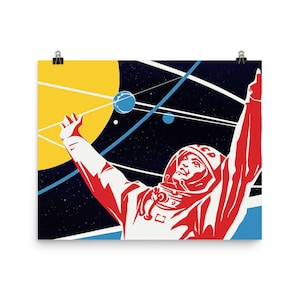 May include: A retro-style poster featuring a red and white astronaut in a space suit with his arm raised, against a dark blue background with yellow, blue, and white planets and stars. The astronaut is wearing a helmet with the word "CCCP" on it.