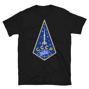May include: Black t-shirt with a blue and yellow emblem featuring a rocket and the text "CCCP".