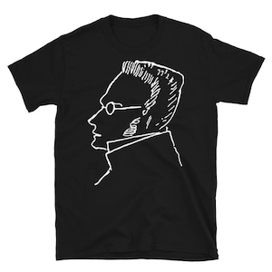 May include: Black t-shirt with a white line drawing of a person wearing glasses.