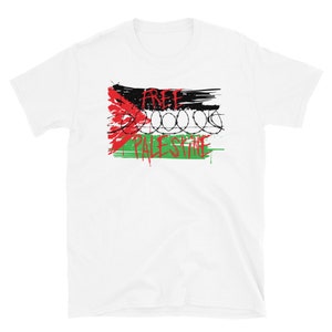 May include: White t-shirt with a red, black, and green graphic of the Palestinian flag with barbed wire and the words "Free Palestine".