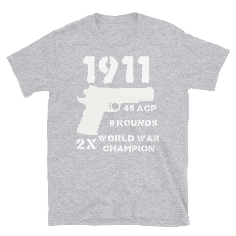 May include: Gray t-shirt with a white graphic of a 1911 pistol, the text "45 ACP", "8 Rounds", "2X World War Champion", and a silhouette of a pistol.