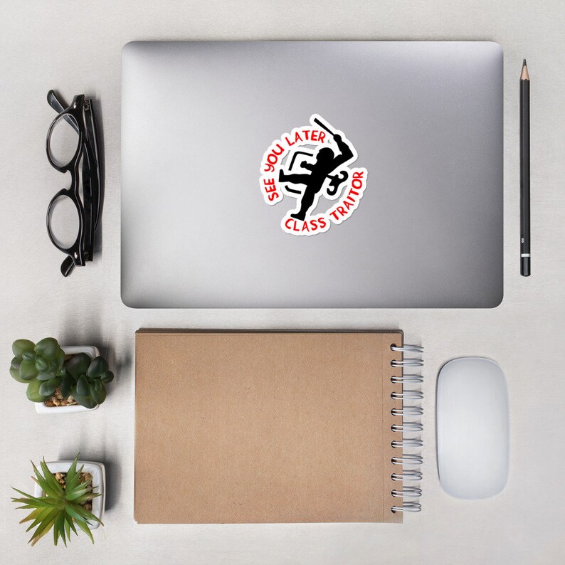 May include: A white sticker with a black silhouette of a person holding a weapon. The text around the person reads "See You Later Class Traitor".