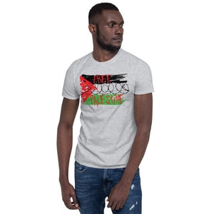 May include: A gray t-shirt with a black and white graphic of a Palestinian flag with barbed wire and the words "Free Palestine".