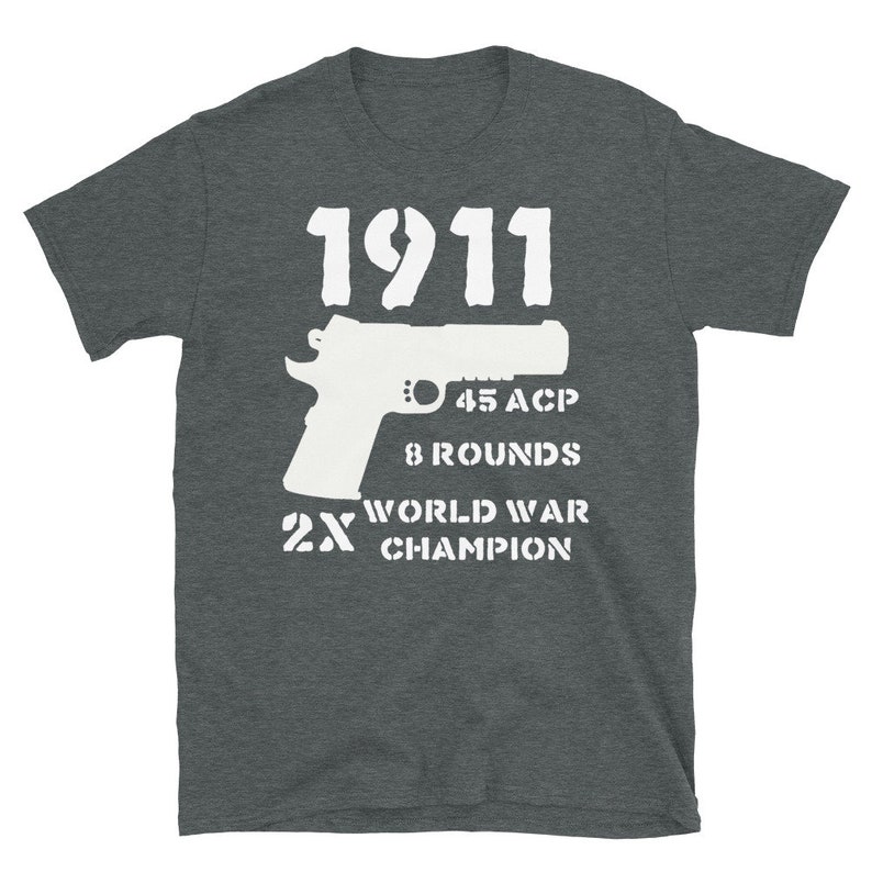 May include: A dark gray t-shirt with a white graphic design of a 1911 pistol, the text "45 ACP", "8 Rounds", "2X World War Champion", and the number "1911".