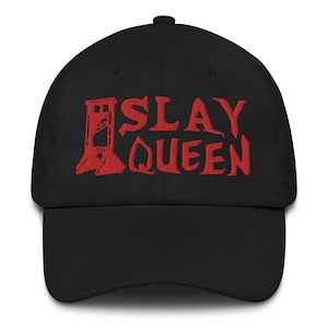 May include: Black baseball cap with red embroidered text that reads "SLAY QUEEN" and a stylized image of a guillotine.