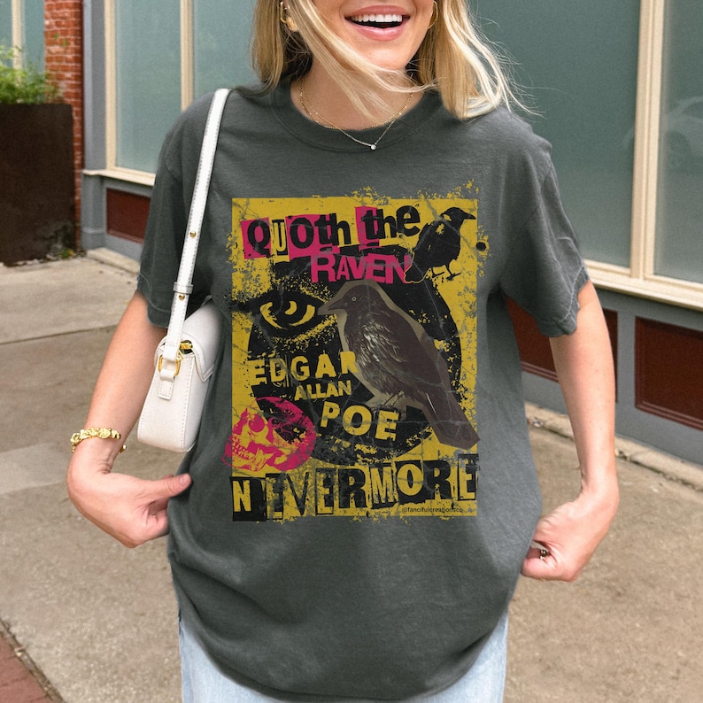 May include: Dark grey t-shirt with a graphic design inspired by Edgar Allan Poe's poem "The Raven." The design includes a raven illustration, the words "Quoth the Raven," "Edgar Allan Poe," and "Nevermore" in a distressed style.