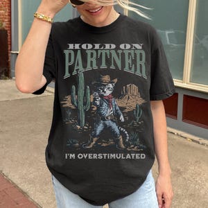 Comfort Colors® Hold On Partner I&#39;m Overstimulated Cowboy Cat Shirt, Funny Animal Meme T-Shirt, Introvert Humor, Trendy Western Graphic Tee