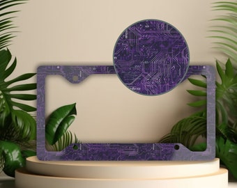 May include: Purple and white license plate frame with a circuit board design.