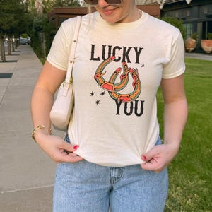 Lucky You Baby Tee: Vintage Tattoo Horseshoe Graphic T-Shirt