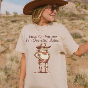 Hold On Partner I&#39;m Overstimulated Shirt, Cowboy Frog Tshirt, Cowboy Frog Unhinged Shirt, Cute Animal Graphic Tee, Funny Frog T-Shirt