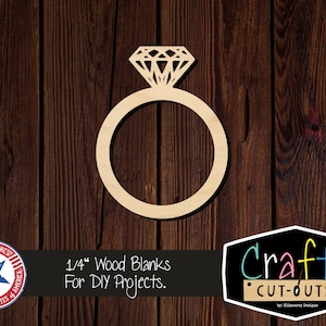 May include: A wooden ring with a diamond cutout, 1/4 inch thick. The ring is on a brown wood background. 1/4" Wood Blanks For DIY Projects. Crafty Cut-Outs by: Klinsrey Designs