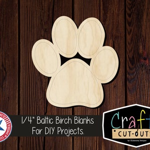 May include: A wooden paw print cutout, 1/4 inch thick, made from Baltic birch. The cutout is unfinished and ready for DIY projects. The text "Crafty Cut-Outs" is visible in the image.