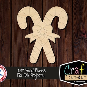 May include: A wooden cutout of two candy canes tied together with a bow. The cutout is 1/4 inch thick and is for DIY projects. The text "Crafty Cut-Outs" is visible in the image.