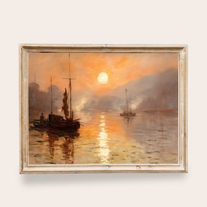 May include: A framed oil painting depicting a seascape at sunset. The painting features two boats silhouetted against a fiery orange sky with a large, bright sun in the center. The water is calm and reflective, with a hazy atmosphere.