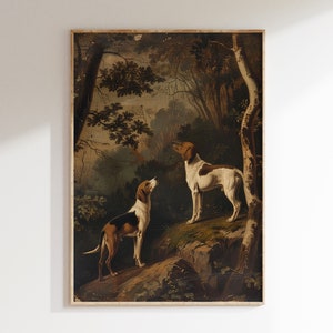 May include: A vintage oil painting depicting two hunting dogs in a woodland setting. The dogs are brown and white with black markings. The painting is framed in a simple wooden frame.