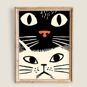 Puede incluir: Una ilustración en blanco y negro de dos caras de gatos, una encima de la otra. El gato de arriba tiene una cara negra con ojos blancos y una nariz roja. El gato de abajo tiene una cara blanca con ojos negros y una nariz negra.