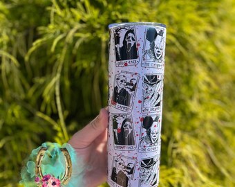 May include: A white tumbler featuring horror movie characters like Ghost Face and Pennywise, with red splatter accents. The tumbler has the text "Ghost Face", "The Clown", and "The Camper".
