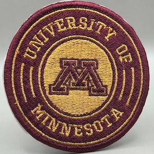 May include: Embroidered patch featuring the University of Minnesota logo. The patch is circular, with maroon and gold colors. The words "UNIVERSITY OF MINNESOTA" are embroidered around the edge, and the center features the interlocking "M" logo.