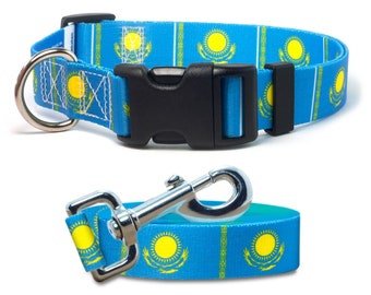 May include: A blue dog collar and leash with the flag of Kazakhstan printed on them. The collar has a black plastic buckle and a silver D-ring. The leash has a silver clip.
