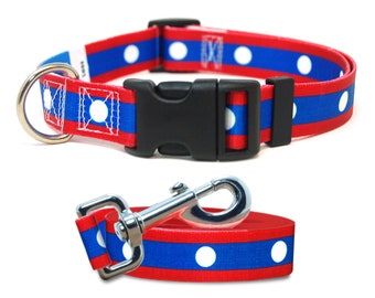 May include: Red and blue dog collar and leash set with white polka dots. The collar has a black plastic buckle and a silver D-ring. The leash has a silver clip.